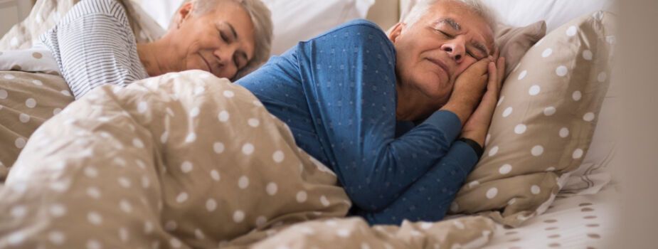 Couple qui profite d'un bon sommeil dans leur lit.